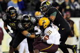 EUGENE,OR - NOVEMBER 14: Linebacker Eddie Pleasant #11, linebacker Spencer Paysinger #35 and linebacker Kenny Rowe #58 of the Oregon Ducks gang up to tackle running back Dimitri Nance #31of the Arizona State Sun Devils in the third quarter of the game at Autzen Stadium on November 14, 2009 in Eugene, Oregon. Oregon Defeated arizona State 44-21.(Photo by Steve Dykes/Getty Images)