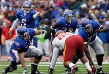 LAWRENCE, KS - OCTOBER 10: Quarterback Todd Reesing #5 and center Sal Capra #59 of the Kansas Jayhawks point out the defense during the game against the Iowa State Cyclones on October 10, 2009 at Memorial Stadium in Lawrence, Kansas. (Photo by Jamie Squire/Getty Images)