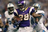 MINNEAPOLIS - NOVEMBER 15:  Adrian Peterson #29 of the Minnesota Vikings carries the ball as Phillip Buchanon #31 of the Detroit Lions defends on November 15, 2009 at Hubert H. Humphrey Metrodome in Minneapolis, Minnesota.  (Photo by Elsa/Getty Images)