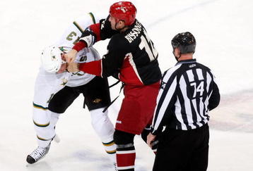 GLENDALE, AZ - NOVEMBER 14:  Paul Bissonnette #12 of the Phoenix Coyotes lands a punch to the head of Krystofer Barch #13 of the Dallas Stars in the second period at Jobing.com Arena on November 14, 2009 in Glendale, Arizona.  (Photo by Jeff Gross/Getty Images)