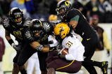 EUGENE,OR - NOVEMBER 14: Linebacker Eddie Pleasant #11, linebacker Spencer Paysinger #35 and linebacker Kenny Rowe #58 of the Oregon Ducks gang up to tackle running back Dimitri Nance #31of the Arizona State Sun Devils in the third quarter of the game at Autzen Stadium on November 14, 2009 in Eugene, Oregon. Oregon Defeated arizona State 44-21.(Photo by Steve Dykes/Getty Images)