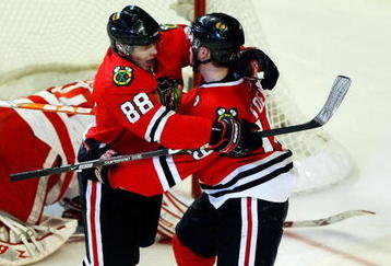 CHICAGO - MAY 24:  Patrick Kane #88 and Jonathan Toews #19 of the Chicago Blackhawks celebrate after Toews scored a goal in the second period against goalie Chris Osgood #30 of the Detroit Red Wings during Game Four of the Western Conference Championship Round of the 2009 Stanley Cup Playoffs on May 24, 2009 at the United Center in Chicago, Illinois.  (Photo by Jim Prisching/Getty Images)