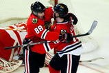 CHICAGO - MAY 24:  Patrick Kane #88 and Jonathan Toews #19 of the Chicago Blackhawks celebrate after Toews scored a goal in the second period against goalie Chris Osgood #30 of the Detroit Red Wings during Game Four of the Western Conference Championship Round of the 2009 Stanley Cup Playoffs on May 24, 2009 at the United Center in Chicago, Illinois.  (Photo by Jim Prisching/Getty Images)