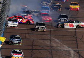 AVONDALE, AZ - NOVEMBER 15:  A multi car incident involving Dale Earnhardt Jr. driver of the #88 AMP Energy/National Guard Chevrolet takes place on the frontstrech during the NASCAR Sprint Cup Series Checker O'Reilly Auto Parts 500 at Phoenix International Raceway on November 15, 2009 in Avondale, Arizona.  (Photo by Robert Laberge/Getty Images for NASCAR)