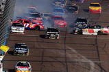 AVONDALE, AZ - NOVEMBER 15:  A multi car incident involving Dale Earnhardt Jr. driver of the #88 AMP Energy/National Guard Chevrolet takes place on the frontstrech during the NASCAR Sprint Cup Series Checker O'Reilly Auto Parts 500 at Phoenix International Raceway on November 15, 2009 in Avondale, Arizona.  (Photo by Robert Laberge/Getty Images for NASCAR)