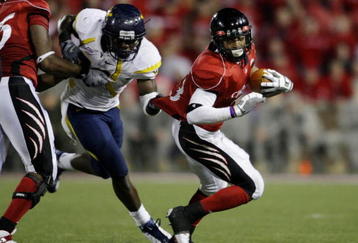 CINCINNATI - NOVEMBER 13: Isaiah Pead #23 of the Cincinnati Bearcats is grabbed by J.T. Thomas #30 of the West Virginia Mountaineers in the fourth quarter of the game at Nippert Stadium on November 13, 2009 in Cincinnati, Ohio. (Photo by Andy Lyons/Getty Images)
