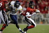CINCINNATI - NOVEMBER 13: Isaiah Pead #23 of the Cincinnati Bearcats is grabbed by J.T. Thomas #30 of the West Virginia Mountaineers in the fourth quarter of the game at Nippert Stadium on November 13, 2009 in Cincinnati, Ohio. (Photo by Andy Lyons/Getty Images)