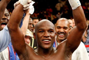LAS VEGAS - SEPTEMBER 19:  Floyd Mayweather Jr., with his advisor Leonard Ellerbe behind him, celebrates his unanimous-decision victory over Juan Manuel Marquez at the MGM Grand Garden Arena September 19, 2009 in Las Vegas, Nevada.  (Photo by Ethan Miller/Getty Images)
