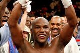 LAS VEGAS - SEPTEMBER 19:  Floyd Mayweather Jr., with his advisor Leonard Ellerbe behind him, celebrates his unanimous-decision victory over Juan Manuel Marquez at the MGM Grand Garden Arena September 19, 2009 in Las Vegas, Nevada.  (Photo by Ethan Miller/Getty Images)
