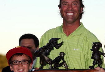 LAKE BUENA VISTA, FL - NOVEMBER 15:  Stephen Ames from Canada (R) and his 10 year old son Ryan hold the winners trophy after winning a playoff in the final round at the Children's Miracle Network Classic at Disney's Magnolia & Disney's Palm Course on November 15, 2009 in Lake Buena Vista, Florida.  (Photo by Marc Serota/Getty Images)