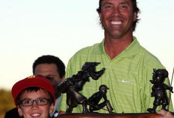 LAKE BUENA VISTA, FL - NOVEMBER 15:  Stephen Ames from Canada (R) and his 10 year old son Ryan hold the winners trophy after winning a playoff in the final round at the Children's Miracle Network Classic at Disney's Magnolia & Disney's Palm Course on November 15, 2009 in Lake Buena Vista, Florida.  (Photo by Marc Serota/Getty Images)
