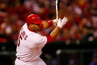 ST. LOUIS, MO - OCTOBER 10:  Albert Pujols #5 of the St. Louis Cardinals hits an RBI single against Los Angeles in the eighth inning of Game Three of the NLDS during the 2009 MLB Playoffs at Busch Stadium on October 10, 2009 in St. Louis, Missouri. (Photo by Dilip Vishwanat/Getty Images)
