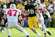 IOWA CITY, IA - OCTOBER 16:  Sam Brownlee of #48 of Iowa attempts to elude A.J. Hawk #47 of Ohio State October 16, 2004 at Kinnick Stadium in Iowa City, Iowa. (Photo by Matthew Stockman/Getty Images)