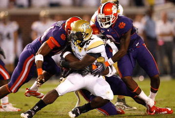 ATLANTA - SEPTEMBER 10:  Running back Jonathan Dwyer #21 of the Georgia Tech Yellow Jackets rushes upfield against Scotty Cooper #44, Andre Branch #40 and DeAndre McDaniel #2 of the Clemson Tigers at Bobby Dodd Stadium on September 10, 2009 in Atlanta, Georgia.  (Photo by Kevin C. Cox/Getty Images)