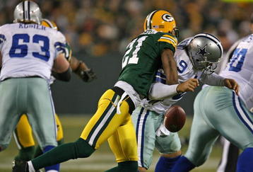 GREEN BAY, WI - NOVEMBER 15: Charles Woodson #21 of the Green Bay Packers hits Tony Romo #9 of the Dallas Cowboys forcing a fumble at Lambeau Field on November 15, 2009 in Green Bay, Wisconsin. The Packers defeated the Cowboys 17-7. (Photo by Jonathan Daniel/Getty Images)