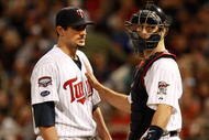 MINNEAPOLIS, MN - OCTOBER 11: Pitcher Carl Pavano #48 of the Minnesota Twins talks with catcher Joe Mauer #2 after Jorge Posada  the New York Yankees hit a home run in the seventh inning to take a 2-1 lead in Game Three of the ALDS during the 2009 MLB Playoffs at the Hubert H. Humphrey Metrodome on October 11, 2009 in Minneapolis, Minnesota. (Photo by Genevieve Ross/Getty Images)