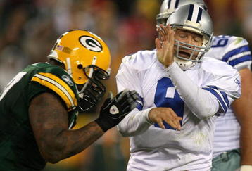 GREEN BAY, WI - NOVEMBER 15: Tony Romo #9 of the Dallas Cowboys closes his eyes as he is hit by Johnny Jolly #97 of the Green Bay Packers at Lambeau Field on November 15, 2009 in Green Bay, Wisconsin. The Packers defeated the Cowboys 17-7.  (Photo by Jonathan Daniel/Getty Images)