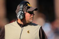 BOULDER, CO - SEPTEMBER 19: Head coach Dave Christensen of the Wyoming Cowboys leads his team against the Colorado Buffaloes at Folsom Field on September 19, 2009 in Boulder, Colorado. (Photo by Doug Pensinger/Getty Images)