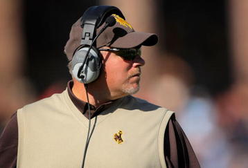 BOULDER, CO - SEPTEMBER 19:  Head coach Dave Christensen of the Wyoming Cowboys leads his team against the Colorado Buffaloes at Folsom Field on September 19, 2009 in Boulder, Colorado.  (Photo by Doug Pensinger/Getty Images)