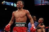 LAS VEGAS - NOVEMBER 14:  Manny Pacquiao celebrates his 12 round TKO victory against Miguel Cotto as Cotto is consoled by referee Kenny Bayless after their WBO welterweight title fight at the MGM Grand Garden Arena on November 14, 2009 in Las Vegas, Nevada.  (Photo by Al Bello/Getty Images)