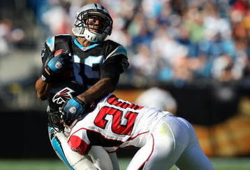 CHARLOTTE, NC - NOVEMBER 15:  Brent Grimes #20 of the Atlanta Falcons tackles Steve Smith #89 of the Carolina Panthers during their game at Bank of America Stadium on November 15, 2009 in Charlotte, North Carolina.  (Photo by Streeter Lecka/Getty Images)