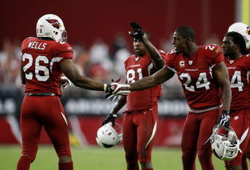 GLENDALE, AZ - NOVEMBER 15:  Beanie Wells #26 of the Arizona Cardinals celebrates a touchdown with Adrian Wilson #24 in the second half against the Seattle Seahawks at University of Phoenix Stadium on November 15, 2009 in Glendale, Arizona. The Cardinals defeated the Seahawks 31-20.  (Photo by Jeff Gross/Getty Images)