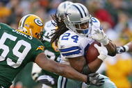 GREEN BAY, WI - NOVEMBER 15: Marion Barber #24 of the Dallas Cowboys breaks away from Brad Jones #59 of the Green Bay Packers at Lambeau Field on November 15, 2009 in Green Bay, Wisconsin. (Photo by Jonathan Daniel/Getty Images)