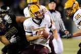EUGENE,OR - NOVEMBER 14: Quarterback Samson Szakacsy #10 of the Arizona State Sun Devils avoids the rush of defensive end Will Tukuafu #39 of the Oregon Ducks in the third quarter of the game at Autzen Stadium on November 14, 2009 in Eugene, Oregon. Oregon Defeated arizona State 44-21. (Photo by Steve Dykes/Getty Images)