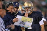 SOUTH BEND, IN - OCTOBER 17: Head coach Charlie Weis of the Notre Dame Fighting Irish gives a play to quarterback Jimmy Clausen #7 during a game against the USC Trojans at Notre Dame Stadium on October 17, 2009 in South Bend, Indiana. USC defeated Notre Dame 34-27. (Photo by Jonathan Daniel/Getty Images)