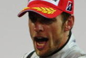 ABU DHABI, UNITED ARAB EMIRATES - NOVEMBER 01:  Jenson Button of Great Britain and Brawn GP celebrates on the podium after finishing third during the Abu Dhabi Formula One Grand Prix at the Yas Marina Circuit on November 1, 2009 in Abu Dhabi, United Arab Emirates.  (Photo by Mark Thompson/Getty Images)