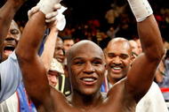 LAS VEGAS - SEPTEMBER 19:  Floyd Mayweather Jr., with his advisor Leonard Ellerbe behind him, celebrates his unanimous-decision victory over Juan Manuel Marquez at the MGM Grand Garden Arena September 19, 2009 in Las Vegas, Nevada.  (Photo by Ethan Miller/Getty Images)