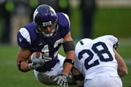 EVANSTON, IL - OCTOBER 31: Andrew Brewer #12 of the Northwestern Wildcats is tackled by Drew Astorino #28 of the Penn State Nittany Lions at Ryan Field on October 31, 2009 in Evanston, Illinois. Penn State defeated Northwestern 34-13. (Photo by Jonathan Daniel/Getty Images)
