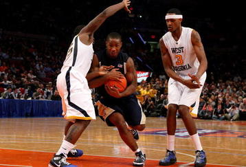 NEW YORK - MARCH 11: Tory Jackson #2 of the Notre Dame Fighting Irish drives to the hoop against Darryl Bryant #25 and Devin Ebanks #3 of the West Virginia Mountaineers during the second round of the Big East Tournament at Madison Square Garden on March 11, 2009 in New York City.  (Photo by Jim McIsaac/Getty Images)
