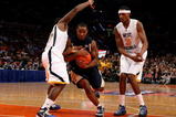 NEW YORK - MARCH 11: Tory Jackson #2 of the Notre Dame Fighting Irish drives to the hoop against Darryl Bryant #25 and Devin Ebanks #3 of the West Virginia Mountaineers during the second round of the Big East Tournament at Madison Square Garden on March 11, 2009 in New York City.  (Photo by Jim McIsaac/Getty Images)