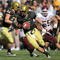 BOULDER, CO - NOVEMBER 07:  Quarterback Tyler Hansen #9 of the Colorado Buffaloes rolls out to deliver a pass against the Texas A&M Aggies during NCAA college football action at Folsom Field on November 7, 2009 in Boulder, Colorado. Colorado defeated Texas A&M 35-34.  (Photo by Doug Pensinger/Getty Images)