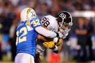 SAN DIEGO - OCTOBER 19:  Eric Weddle #32 of the San Diego Chargers takes down Tony Scheffler #88 of the Denver Broncos at Qualcomm Stadium on October 19, 2009 in San Diego, California.  (Photo by Jacob de Golish/Getty Images)