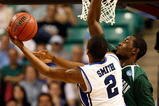 GREENSBORO, NC - MARCH 19:  Nolan Smith #2 of the Duke Blue Devils lays in a basket against Kyrie Sutton #33 of the Binghamton Bearcats during the first round of the NCAA Division I Men's Basketball Tournament at the Greensboro Coliseum on March 19, 2009 in Greensboro, North Carolina.  (Photo by Streeter Lecka/Getty Images)