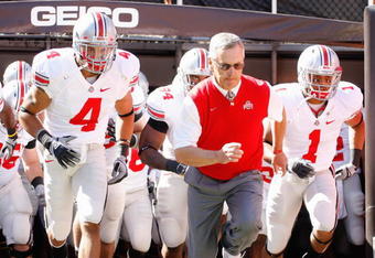 CLEVELAND - SEPTEMBER 19: Quarterback Kurt Coleman #4 and head coach Jim Tressel of the Ohio State Buckeyes jog onto the field before the game against the Toledo Rockets at Cleveland Browns Stadium on September 19, 2009 in Cleveland, Ohio. The Ohio State Buckeyes shutout the Toledo Rockets 38-0. (Photo by Gregory Shamus/Getty Images)
