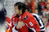 WASHINGTON - NOVEMBER 01:  Alex Ovechkin #8 of the Washington Capitals holds his shoulder as he is escorted to the penalty box after receiving a roughing penalty in the second period against the Columbus Blue Jackets at the Verizon Center on November 1, 2009 in Washington, DC.  (Photo by Greg Fiume/Getty Images)