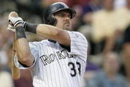 DENVER - JULY 17:  Right fielder Larry Walker #33 of the Colorado Rockies watches the flight of the ball as he follows through on a swing during the game against the San Francisco Giants at Coors Field on July 17, 2004 in Denver, Colorado.  The Giants won 4-0. (Photo by Brian Bahr/Getty Images)
