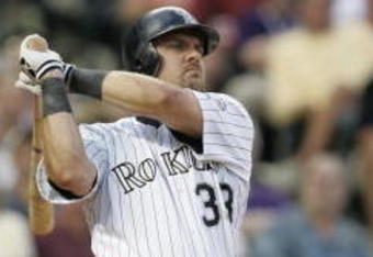 DENVER - JULY 17:  Right fielder Larry Walker #33 of the Colorado Rockies watches the flight of the ball as he follows through on a swing during the game against the San Francisco Giants at Coors Field on July 17, 2004 in Denver, Colorado.  The Giants won 4-0. (Photo by Brian Bahr/Getty Images)
