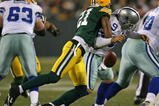 GREEN BAY, WI - NOVEMBER 15: Charles Woodson #21 of the Green Bay Packers hits Tony Romo #9 of the Dallas Cowboys forcing a fumble at Lambeau Field on November 15, 2009 in Green Bay, Wisconsin. The Packers defeated the Cowboys 17-7. (Photo by Jonathan Daniel/Getty Images)