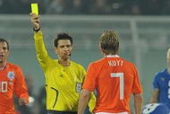 PESCARA, ITALY - NOVEMBER 14:  The refree Claudio Circhetta shows the yellow card to Dirk Kuyt of Holland  during the International Friendly Match between Italy and Holland at Adriatico Stadium on November 14, 2009 in Pescara, Italy.  (Photo by Giuseppe Bellini/Getty Images)
