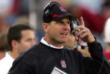 PALO ALTO, CA - NOVEMBER 07:  Stanford Cardinal head coach Jim Harbaugh listens to his headset during their game against the Oregon Ducks at Stanford Stadium on November 7, 2009 in Palo Alto, California.  (Photo by Ezra Shaw/Getty Images)