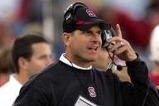 PALO ALTO, CA - NOVEMBER 07:  Stanford Cardinal head coach Jim Harbaugh listens to his headset during their game against the Oregon Ducks at Stanford Stadium on November 7, 2009 in Palo Alto, California.  (Photo by Ezra Shaw/Getty Images)