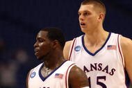 MINNEAPOLIS - MARCH 20:  (L-R) Sherron Collins #4 and Cole Aldrich #45 of the Kansas Jayhawks look on against the North Dakota State Bison during the first round of the NCAA Division I Men's Basketball Tournament at the Hubert H. Humphrey Metrodome on March 20, 2009 in Minneapolis, Minnesota. Kansas won 84-74. (Photo by Jonathan Daniel/Getty Images)