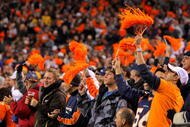 DENVER - NOVEMBER 09:  Fans support the Denver Broncos against the Pittsburgh Steelers defense on during NFL action at Invesco Field at Mile High on November 9, 2009 in Denver, Colorado. The Steelers defeated the Broncos 28-10.  (Photo by Doug Pensinger/Getty Images)