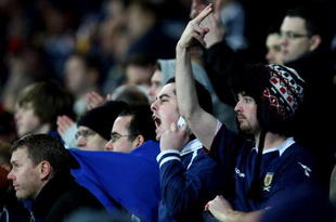 CARDIFF, WALES - NOVEMBER 14:  Scottish fans show feelings towards their team's performance during the International Friendly match between Wales and Scotland at the Cardiff City Stadium on November 14, 2009 in Cardiff, Wales.  (Photo by Richard Heathcote/Getty Images)