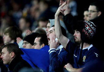 CARDIFF, WALES - NOVEMBER 14:  Scottish fans show feelings towards their team's performance during the International Friendly match between Wales and Scotland at the Cardiff City Stadium on November 14, 2009 in Cardiff, Wales.  (Photo by Richard Heathcote/Getty Images)