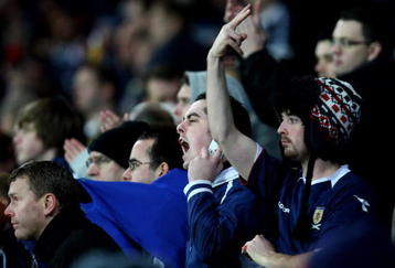 CARDIFF, WALES - NOVEMBER 14:  Scottish fans show feelings towards their team's performance during the International Friendly match between Wales and Scotland at the Cardiff City Stadium on November 14, 2009 in Cardiff, Wales.  (Photo by Richard Heathcote/Getty Images)